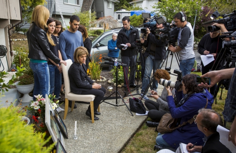 Tima Kurdi, sister of Syrian refugee Abdullah Kurdi whose sons Aylan and Galip and wife Rehan were among 12 people who drowned in Turkey trying to reach Greece, cries while speaking to the media outside her home with friends and family behind her in Coquitlam, British Columbia, September 3, 2015. A photograph of the tiny body of 3-year old Aylan Kurdi washed up in the Aegean resort of Bodrum swept social media on Wednesday and featured on front pages on Thursday, spawning sympathy and outrage at the perceived inaction of developed nations in helping refugees.