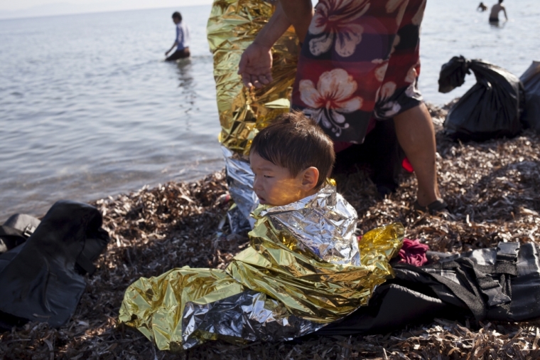Afghan refugee child Elias, 2, from Kabul wears a thermal blanket moments after arriving on a dinghy on the Greek island of Lesbos, September 4, 2015. European Union officials are preparing to push EU governments to take in many more asylum-seekers from pressured frontier states, including Hungary, and seeking to overcome resistance to a quota system in eastern Europe.