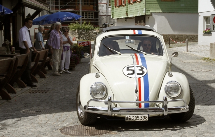 People look at a vintage Volkswagen Beetle car tuned like the famous 'Herbie' car in the U.S. movie 'The Love Bug' from 1968 in the central Swiss village of Andermatt, Switzerland, July 8, 2011.