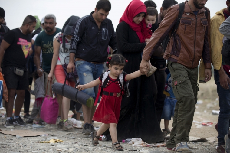 Migrants walk on a dirt road after crossing the Macedonian-Greek border near Gevgelija, Macedonia, September 6, 2015. Several thousand migrants in Macedonia boarded trains on Sunday to travel north after spending a night in a provisional camp. Macedonia has organised trains twice a day to the north border where migrants cross into Serbia to make their way to Hungary. Since June, Macedonian authorities have said that more than 60,000 migrants have entered the country, and around 1,500 entered just in one day, mainly refugees from Syria.