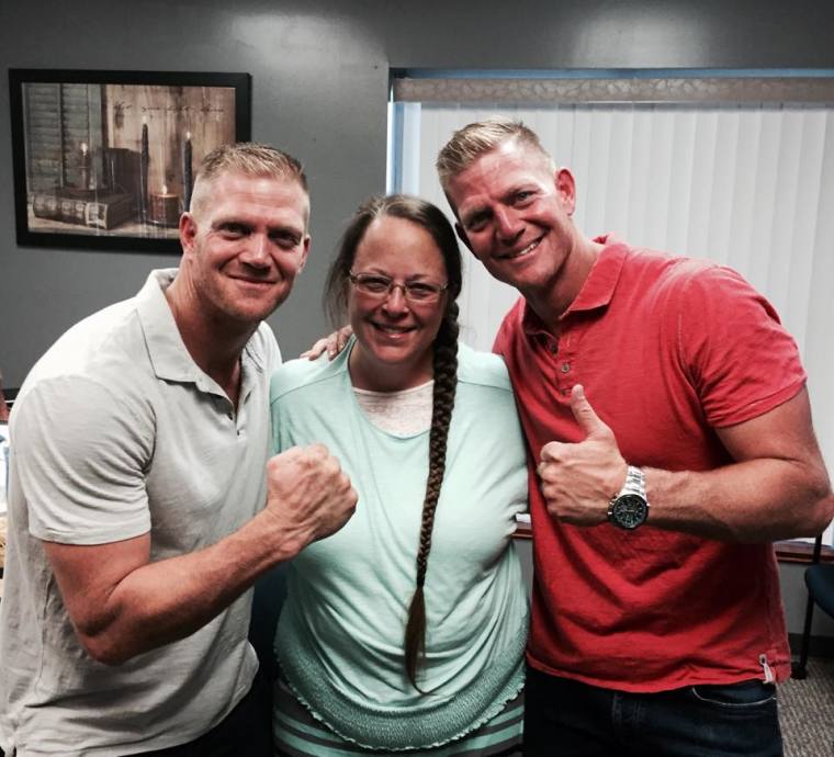 Kim Davis (C), poses with David Benham (L) and his brother Jason Benham (R), in Grayson, Kentucky, on September 8, 2015.