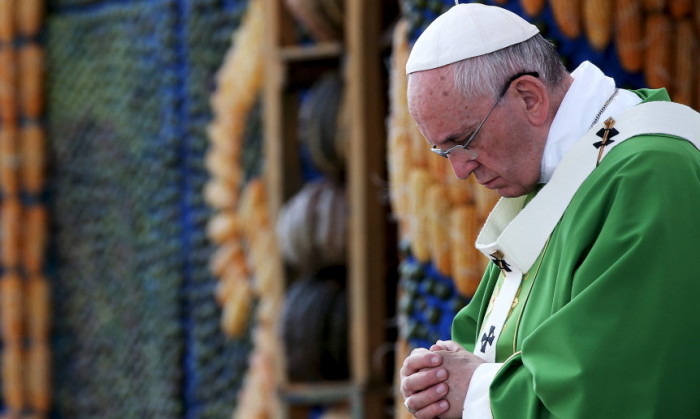 Pope Francis prays as he leads a mass in Asuncion, Paraguay, July 12, 2015.