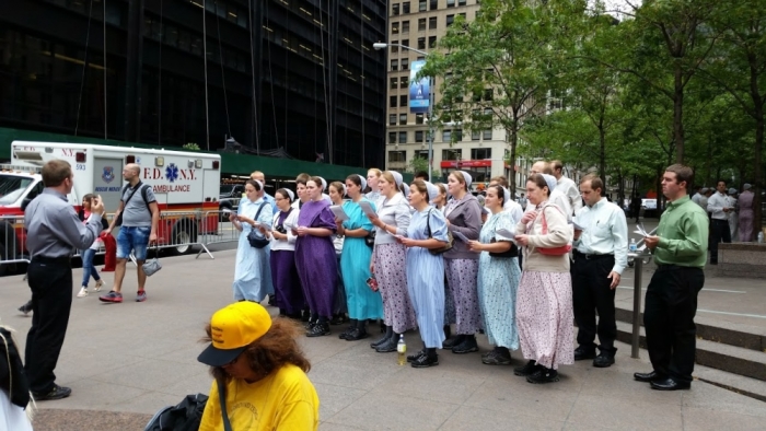A Mennonite choir from Pioneer Valley Mennonite Fellowship in Russell, Massachusetts, sings hymns in Zuccotti Park in New York City near World Trade Center on September 11, 2015.