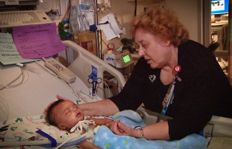 Chaplain Kathleen Ennis-Durstine, senior chaplain at Children’s National Medical Center in Washington, D.C., visits a sick child.