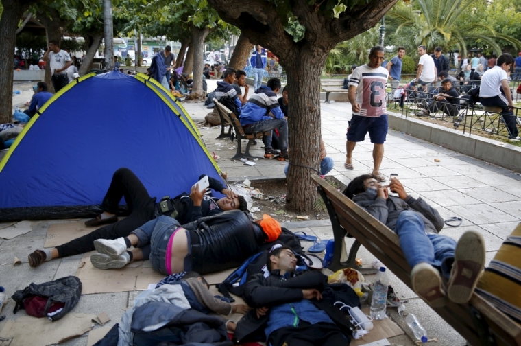 Afghan refugees sleep in Victoria Square at the center of Athens after arriving aboard passenger ships from Lesbos Island, Greece, September 11, 2015. Some 7,600 migrants, many of them refugees from the Syrian war, entered Macedonia from Greece between 6 p.m. on Wednesday and 6 p.m. on Thursday, an official with the United Nations refugee agency said on the border. Migrants are flowing in increasing numbers through the Balkan peninsula towards Hungary as Greece ferries them from inundated islands to Athens, from where they head north to Macedonia.