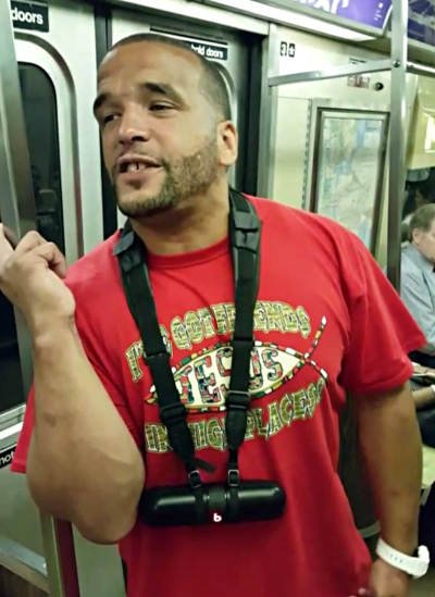 Gospel rapper Brimstone (born Elsworth Hewitt) addresses commuters on the subway in New York City, Aug. 6, 2015.