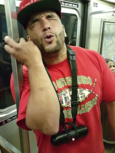 Gospel rapper Brimstone (born Elsworth Hewitt) performs a song on the subway in New York City, Aug. 6, 2015.