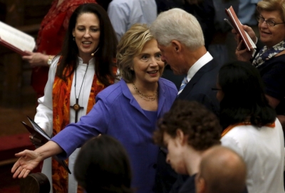 U.S. Democratic presidential candidate Hillary Clinton gestures to former U.S. President Bill Clinton to take a seat first at the Foundry United Methodist Church's bicentennial service in Washington, September 13, 2015.