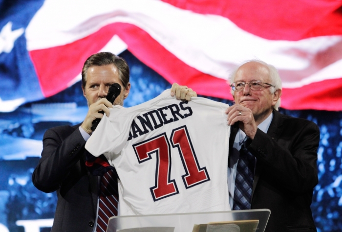 U.S. Democratic presidential candidate Sen. Bernie Sanders, I-Vermont, receives a football jersey from Jerry Falwell Jr. (L), president of Liberty University after addressing students in Lynchburg, Virginia, September 14, 2015.