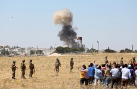 Smoke rises in the Syrian town of Kobani as it is seen from the Turkish border town of Suruc in Sanliurfa province, Turkey, June 25, 2015. Islamic State fighters launched simultaneous attacks against the Syrian government and Kurdish militia overnight, moving back onto the offensive after losing ground in recent days to Kurdish-led forces near the capital of their "caliphate." After recent losses to the Kurdish forces backed by U.S.-led air strikes, Islamic State sought to retake the initiative with attacks on the Kurdish-held town of Kobani at the Turkish border and government-held areas of Hasaka city in the northeast.