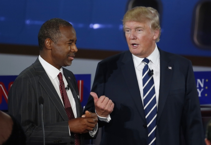 Republican U.S. presidential candidates Dr. Ben Carson (L) and businessman Donald Trump talk during a commercial break at the second official Republican presidential candidates debate of the 2016 U.S. presidential campaign at the Ronald Reagan Presidential Library in Simi Valley, California, United States, September 16, 2015.