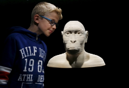 A young visitor observes a 3D model of an australopythecus afarensis during a visit to the "Gallery of Humankind. Our evolution, our body" exhibition at the Museum of Natural Sciences in Brussels, Belgium, May 22, 2015.
