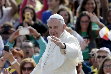 Pope Francis waves as he arrives to lead his Wednesday general audience in Saint Peter's Square at the Vatican, September 9, 2015.