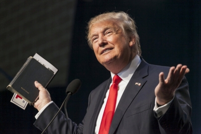 U.S. Republican presidential candidate Donald Trump holds his bible while speaking at the Iowa Faith and Freedom Coalition Forum in Des Moines, Iowa, September 19, 2015.