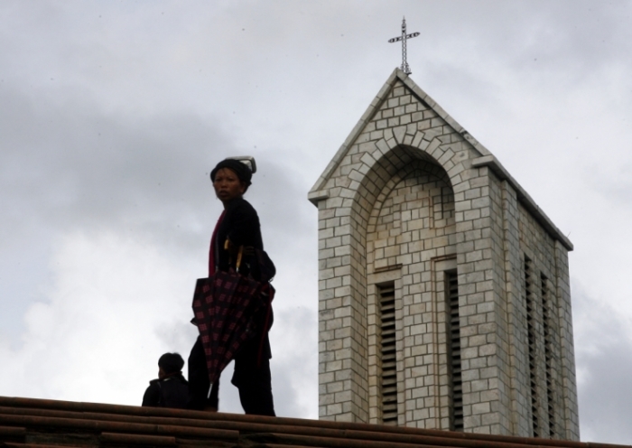 A Dao woman walks past a church in Sapa town in northern Lao Cai province, 350 km (217 miles) from Hanoi September 2, 2007.