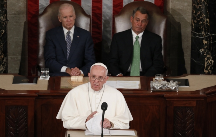 Pope Francis addresses a joint meeting of the U.S. Congress as Vice President Joe Biden (L) and Speaker of the House John Boehner (R) look on in the House of Representatives Chamber on Capitol Hill in Washington, September 24, 2015.