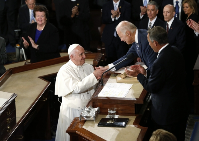 Pope Francis (L) is greeted by U.S. Vice President Joe Biden as the pope arrives in the House Chamber prior to addressing a joint meeting of the U.S. Congress on Capitol Hill in Washington, September 24, 2015.