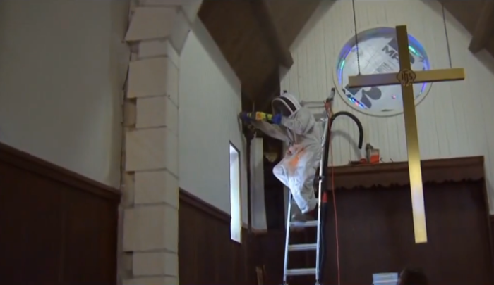 A rescue volunteer from Central Texas Bee Rescue and Preserve works to remove an estimated one million bees from the walls of Salem Lutheran Church in Austin, Texas, in September, 2015.