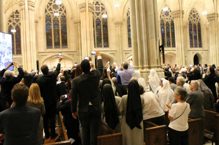 Worshippers strain to see Pope Francis as he enters St. Patrick's Cathedral in New York City on September 14, 2015.