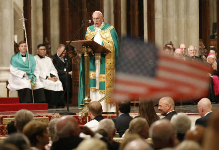 Parishoners wave U.S. flags as Pope Francis presides over Evening Prayer at St. Patrick's Cathedral in New York City, September 24, 2015.