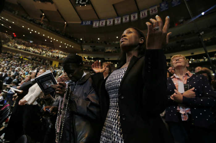 Church faithful watch as Pope Francis celebrates mass at Madison Square Garden in New York City, September 25, 2015.