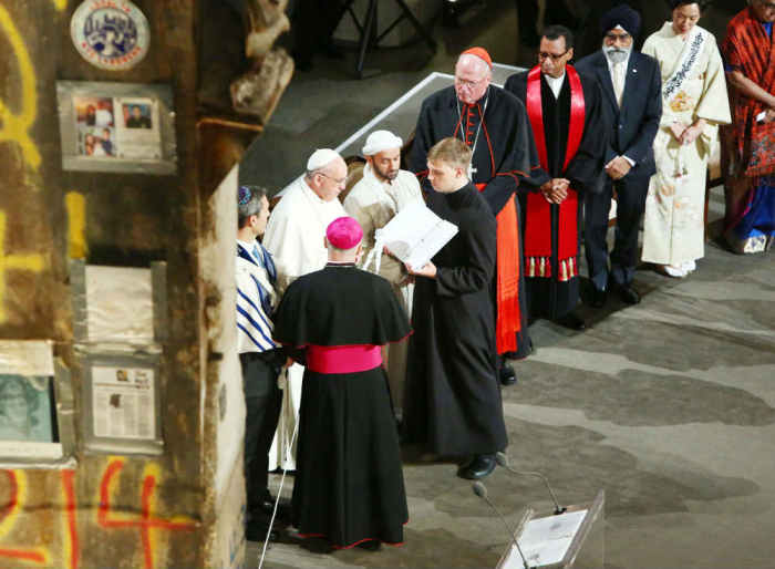 Pope Francis, second left, reads a passage during a multi-religious service at the 9/11 Memorial and Museum on September 25, 2015, in New York City.