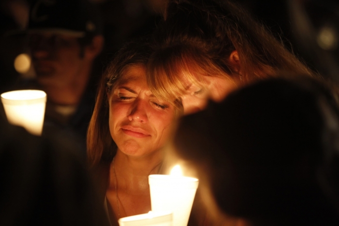 People take part in candle light vigil following a mass shooting at Umpqua Community College in Roseburg, Oregon, October 1, 2015. A gunman opened fire at a community college in southwest Oregon on Thursday, killing nine people and wounding seven others before police shot him to death, authorities said, in the latest mass killing to rock an American campus.