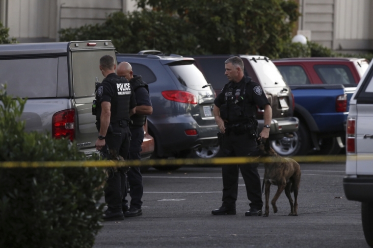 Police investigators are seen following a mass shooting at Umpqua Community College in Roseburg, Oregon, October 1, 2015. A gunman opened fire at a community college in southwest Oregon on Thursday, killing nine people and wounding seven others before police shot him to death, authorities said, in the latest mass killing to rock an American campus.