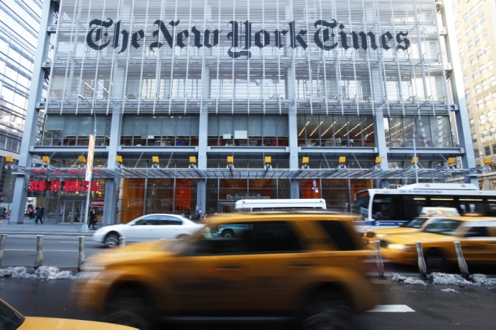 Vehicles drive past the New York Times headquarters in New York on March 1, 2010. 