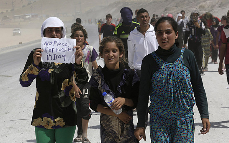 Displaced people from the minority Yazidi sect, who fled the violence in the Iraqi town of Sinjar, march in a demonstration at the Iraqi-Turkish border in this undated photo.
