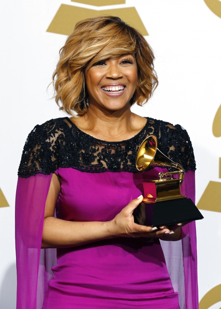 Erica Campbell holds the award for Best Gospel Album for "Help" backstage during the awards pre-telecast at the 57th annual Grammy Awards in Los Angeles, California, February 8, 2015.
