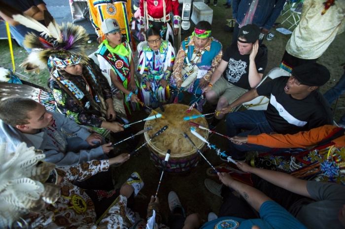 Revellers play the drum and sing during a 'pow-wow' celebrating the Indigenous Peoples' Day Festival in Randalls Island, New York, October 11, 2015. The festival is held as a counter-celebration to Columbus Day and is to promote Native American culture and history.