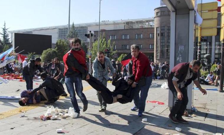 People carry an injured man after an explosion during a peace march in Ankara, Turkey, on October 10, 2015.