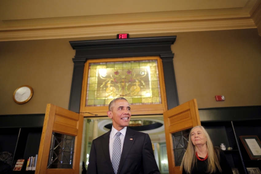 U.S. President Barack Obama arrives at the State Library of Iowa accompanied by Pulitzer Prize writer Marilynne Robinson (R) in Des Moines, Iowa September 14, 2015. Obama is traveling to Des Moines, Iowa to holds a town hall to discuss college access and affordability.