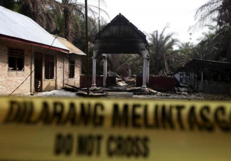 Police tape restricts access to a burned church at Suka Makmur Village in Aceh Singkil, Indonesia Aceh province, October 18, 2015.