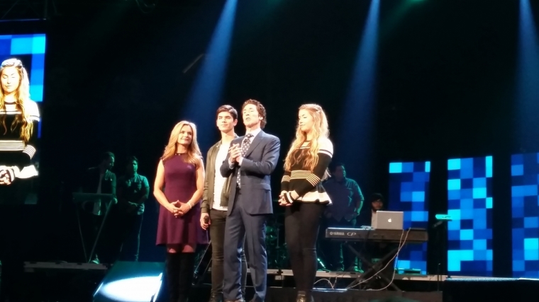Joel Osteen is joined by his wife Victoria and children Alexandra and Jonathan on stage at afternoon session of Night of Hope at the Barclays Center in Brooklyn, New York on Oct. 16, 2015.