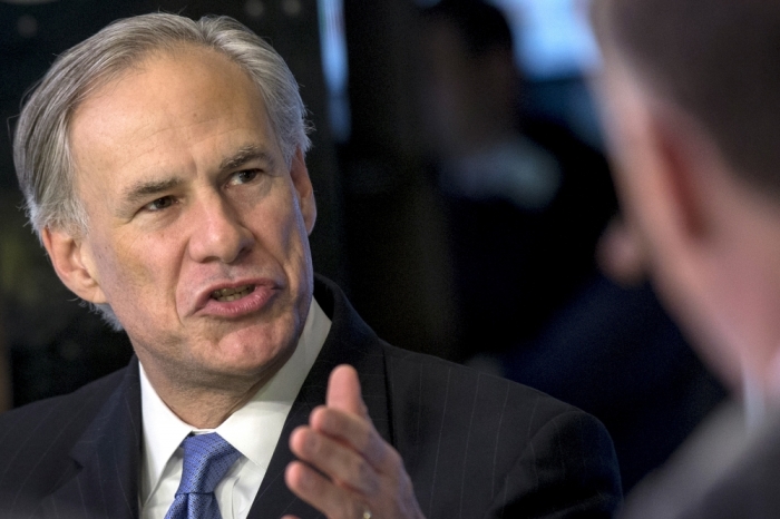 Texas governor Greg Abbott speaks during an interview on the floor of the New York Stock Exchange July 14, 2015.