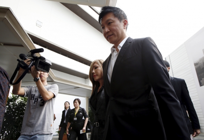 City Harvest Church founder Kong Hee (R) and his wife Sun Ho, also known as Ho Yeow Sun, arrive at the State Courts in Singapore, October 21, 2015, where a verdict is expected to be delivered for their trial of misappropriating S million (.5 million) of church funds and falsifying the church's accounts.