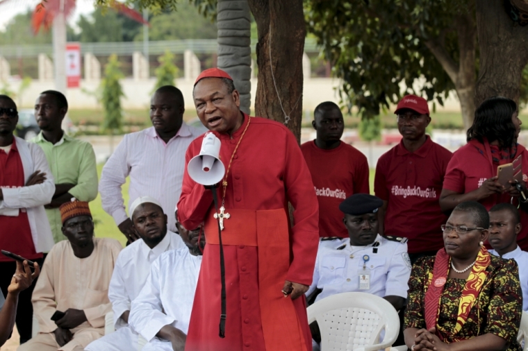 Catholic Archbishop of Abuja John Onaiyekan addresses Bring Back Our Girls campaigners during a protest procession marking the 500th day since the abduction of girls in Chibok, along a road in Abuja August 27, 2015. The Islamist militant group Boko Haram kidnapped some 270 girls and women from a school in Chibok a year ago. More than 50 eventually escaped, but at least 200 remain in captivity, along with scores of other girls kidnapped before the Chibok girls.