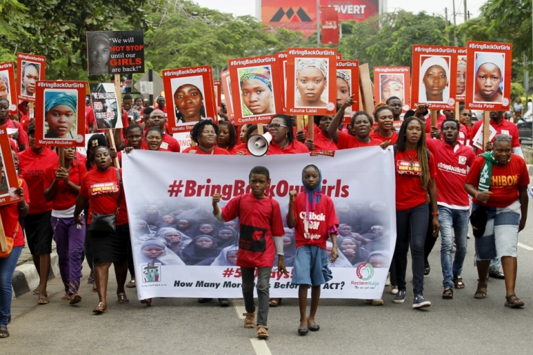 Bring Back Our Girls (BBOG) campaigners hold banners as they walk during a protest procession marking the 500th day since the abduction of girls in Chibok, along a road in Lagos August 27, 2015. The Islamist militant group Boko Haram kidnapped some 270 girls and women from a school in Chibok a year ago. More than 50 eventually escaped, but at least 200 remain in captivity, along with scores of other girls kidnapped before the Chibok girls. Akinleye