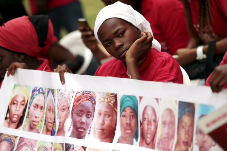 Bring Back Our Girls campaigners look on during a protest procession marking the 500th day since the abduction of girls in Chibok, along a road in Abuja August 27, 2015. The Islamist militant group Boko Haram kidnapped some 270 girls and women from a school in Chibok a year ago. More than 50 eventually escaped, but at least 200 remain in captivity, along with scores of other girls kidnapped before the Chibok girls.