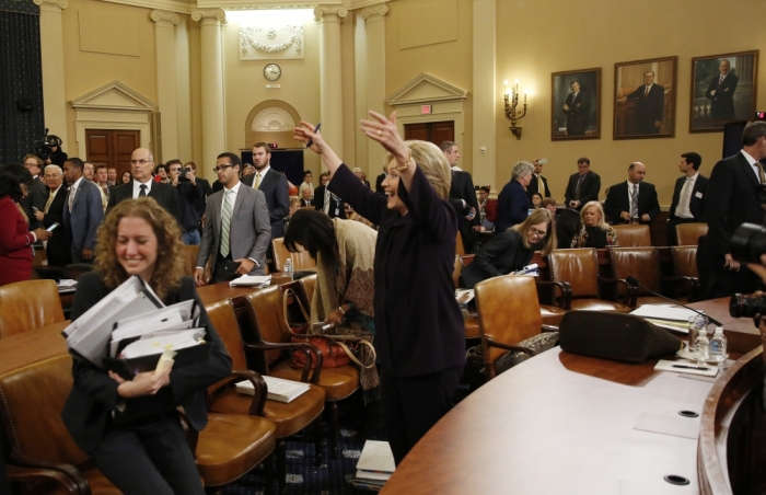 Democratic presidential candidate Hillary Clinton reacts as she stands up after her second round of testimony in front of the House Select Committee on Benghazi, on Capitol Hill in Washington October 22, 2015. The congressional committee is investigating the deadly 2012 attack on the U.S. diplomatic mission in Benghazi, Libya, when Clinton was the secretary of state.