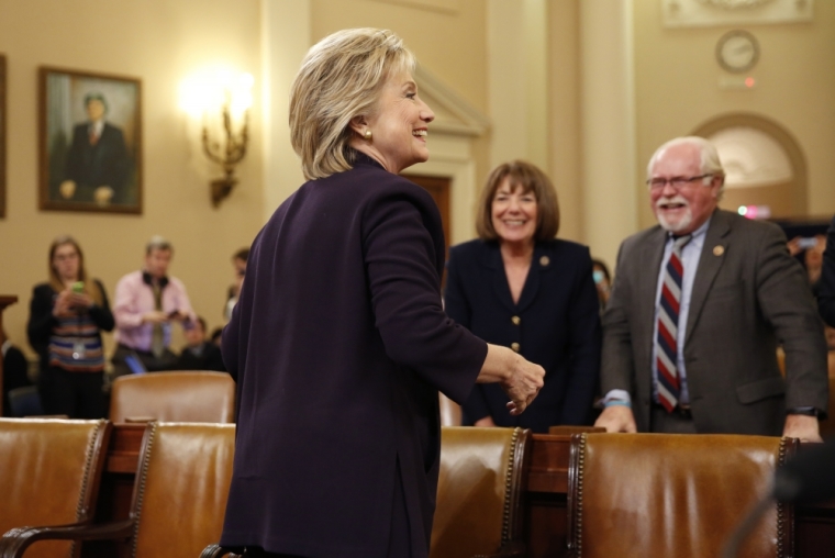 Democratic presidential candidate and former Secretary of State Hillary Clinton talks with Democratic members of congress as she returns to resume her testimony after a lunch break at the House Select Committee on Benghazi about the attack on a U.S. diplomatic mission in Benghazi, Libya, on Capitol Hill in Washington October 22, 2015.