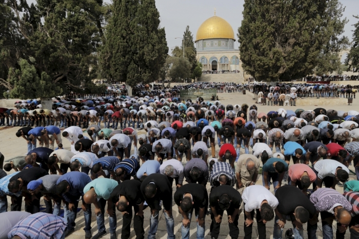 The Dome of the Rock is seen in the background as Palestinian men take part in Friday prayers on the compound known to Muslims as Noble Sanctuary and to Jews as Temple Mount in Jerusalem's Old City, October 23, 2015. Palestinian factions called for mass rallies against Israel in the occupied West Bank and East Jerusalem in a 'day of rage' on Friday, as world and regional powers pressed on with talks to try to end more than three weeks of bloodshed. Israeli authorities also lifted restrictions on Friday that had banned men aged under 40 from using the flashpoint al-Aqsa mosque compound in Jerusalem's Old City - a move seen as a bid to ease Muslim anger.