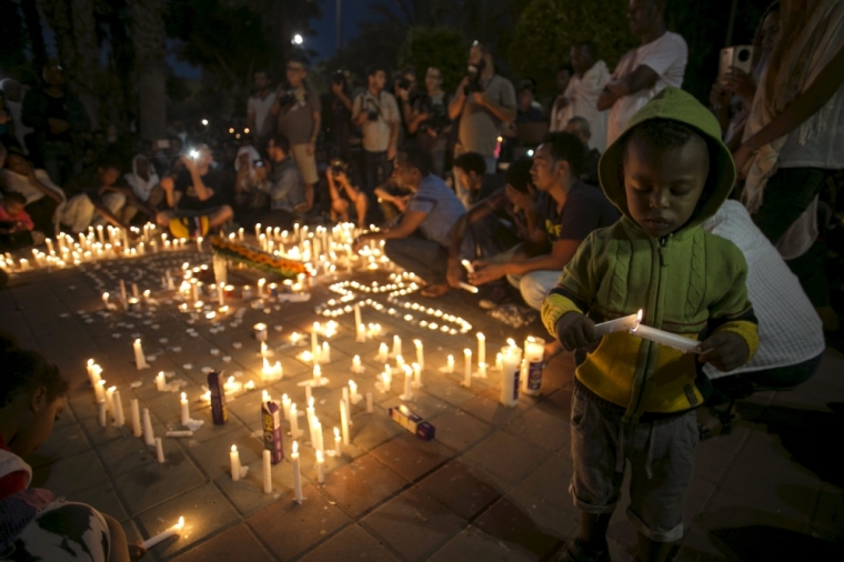 Israelis and fellow community members attend a memorial ceremony for Habtom Zarhum, an Eritrean migrant who was mistaken for a gunman at a shooting attack earlier in the week, in Tel Aviv, Israel, October 21, 2015. Zarhum was shot by a security guard and kicked by an angry Israeli crowd that mistook him for a gunman, during an attack on a bus station on Sunday in the southern city of Beersheba, in the latest wave of Israeli-Palestinian violence.