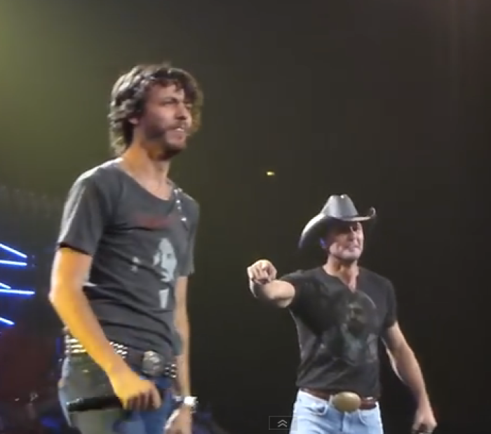 Country music singers Chris Janson and Tim McGraw perform 'Buy Me a Boat' at Nashville's Bridgestone Arena on August 15, 2015.