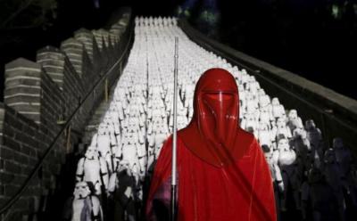 A fan dressed as a character from 'Star Wars' poses for a photo in front of five hundred replicas of the Stormtrooper characters at the Juyongguan section of the Great Wall of China during a promotional event for 'Star Wars: The Force Awakens' film, on the outskirts of Beijing, China, October 20, 2015.