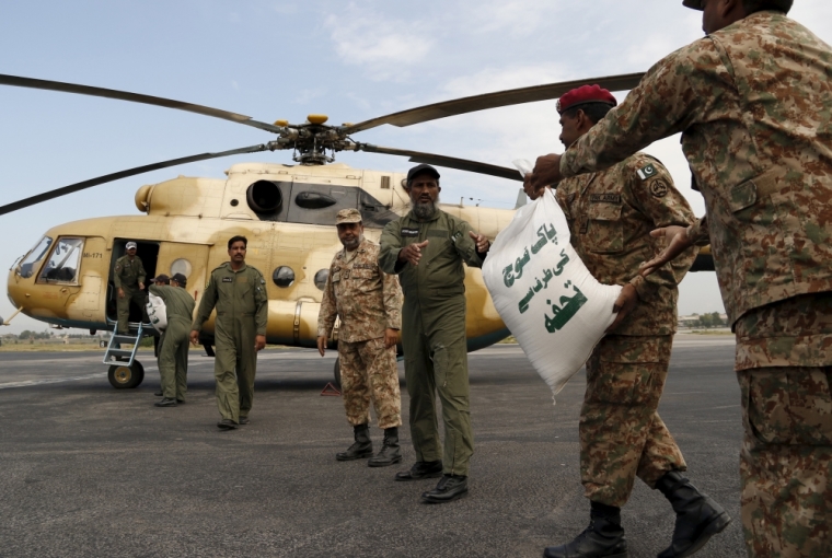 Army soldiers load sacks of food aid on a helicopter, to distribute in earthquake stricken areas in Peshawar, Pakistan October 27, 2015. The Taliban urged aid agencies on Tuesday to push ahead in delivering emergency supplies to victims of the massive earthquake that hit remote mountainous regions of northern Afghanistan and Pakistan, killing at least 300 people. With harsh winter weather setting in across the rugged Hindu Kush mountains where the earthquake struck, the plight of thousands of people left homeless by the earthquake was becoming increasingly serious. However the relief effort is being complicated by unstable security caused by the Taliban insurgency, which has made large parts of the affected areas unsafe for international organisations and government troops. The words on the sack reads in Urdu, 'A gift from the Pakistan Army.'