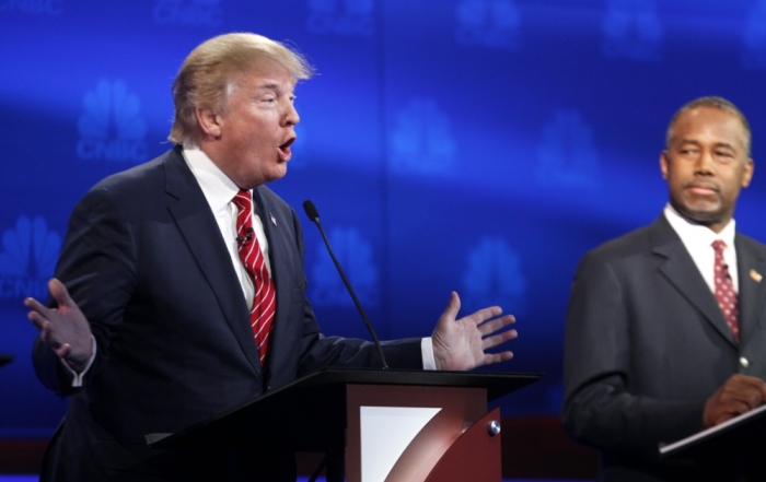 Republican U.S. presidential candidate businessman Donald Trump speaks as Dr. Ben Carson (R) listens at the 2016 U.S. Republican presidential candidates debate held by CNBC in Boulder, Colorado, October 28, 2015.