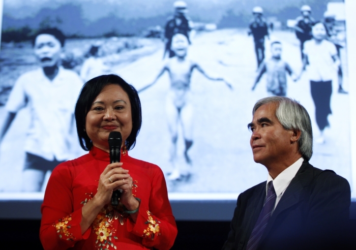Photojournalist Nick Ut and Kim Phuc (L) attend the presentation of the latest Leica equipment at Photokina 2012, the world's largest fair for imaging, in Cologne, Germany, September 17, 2012. Ut took the iconic 1972 Vietnam War photograph of Kim Phuc running naked down a road after being burned in a napalm attack near Trang Bang.